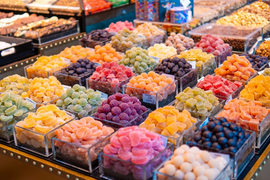 An assortment of colorful macarons and French pastries in a bakery display