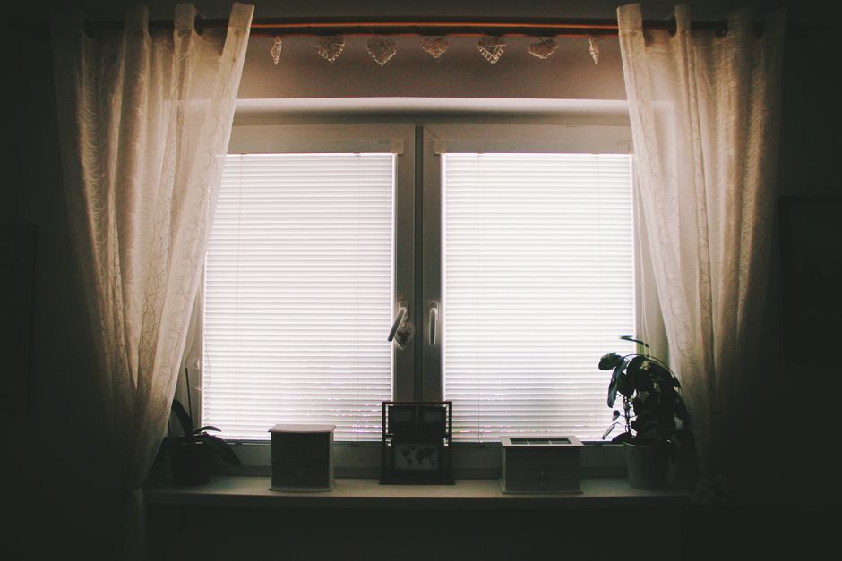 A cozy aesthetic desk setup with a smartphone showing the TikTok profile screen