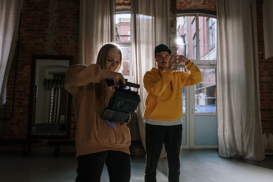 A dancer filming a TikTok routine on a smartphone set on a ring light tripod