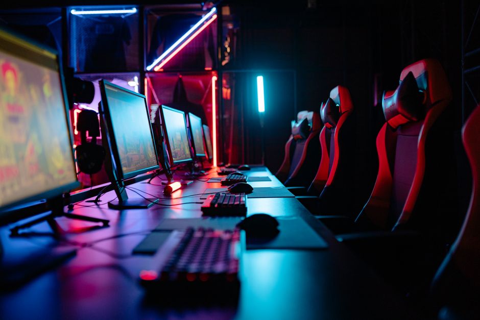 A gaming setup with neon lights and a gamer checking their TikTok analytics