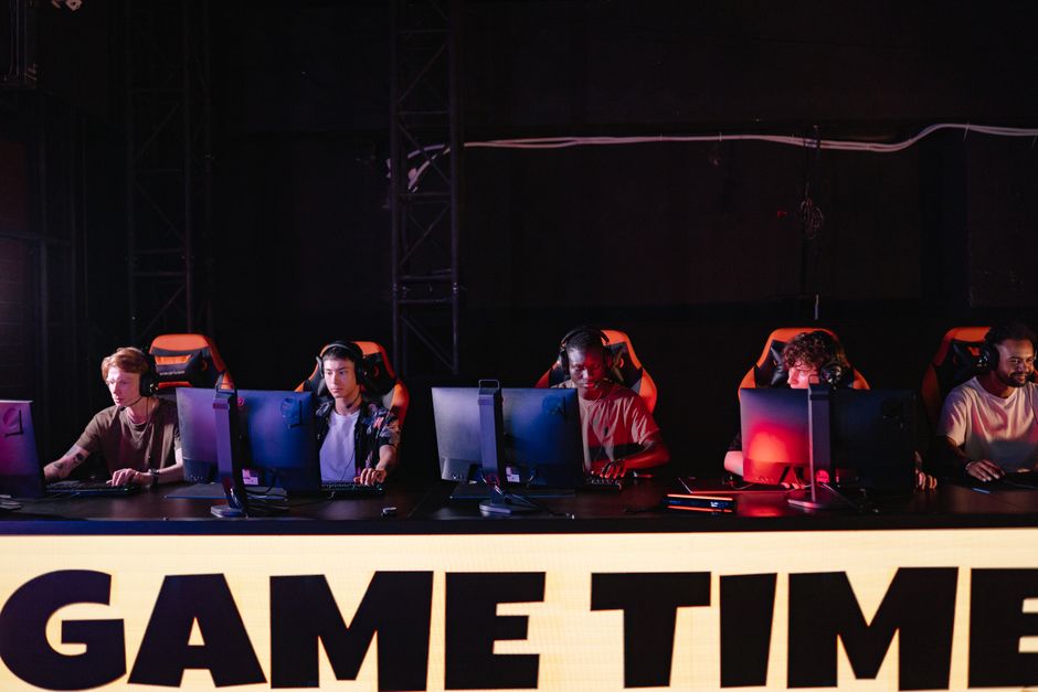 A gaming squad streaming together with colorful RGB backlighting and headsets