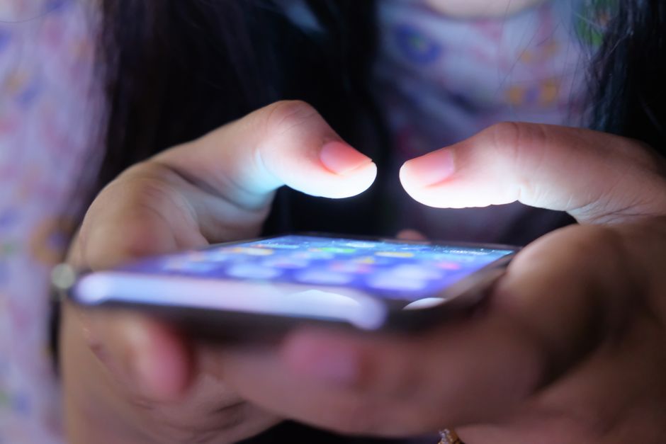 A glowing smartphone displaying a TikTok profile with a creative username