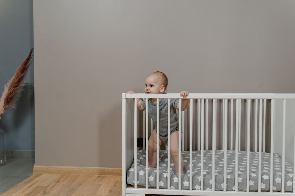 A minimalist nursery with clean lines, light wood furnishings, and wooden name blocks spelling out short baby names