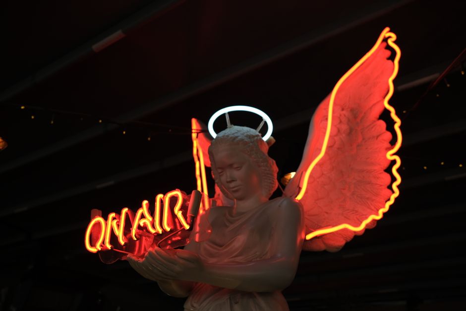 A neon-lit aesthetic workspace with someone brainstorming trendy social media usernames in a notebook