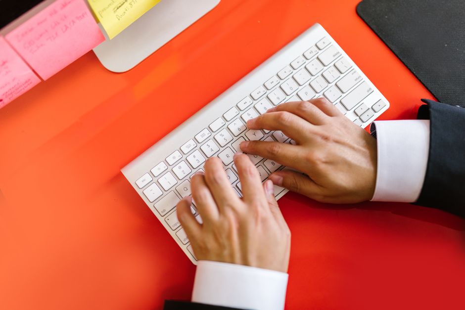 A person typing a TikTok profile address directly into a web browser on a laptop