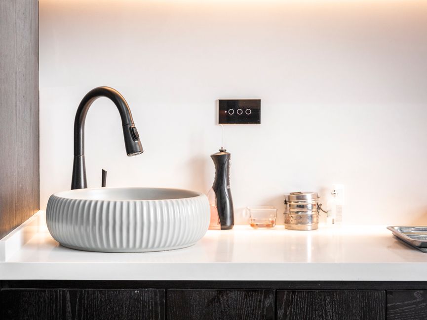 A sleek, minimalist marble vanity with luxury skincare products and gold jewelry showcasing clean girl aesthetics