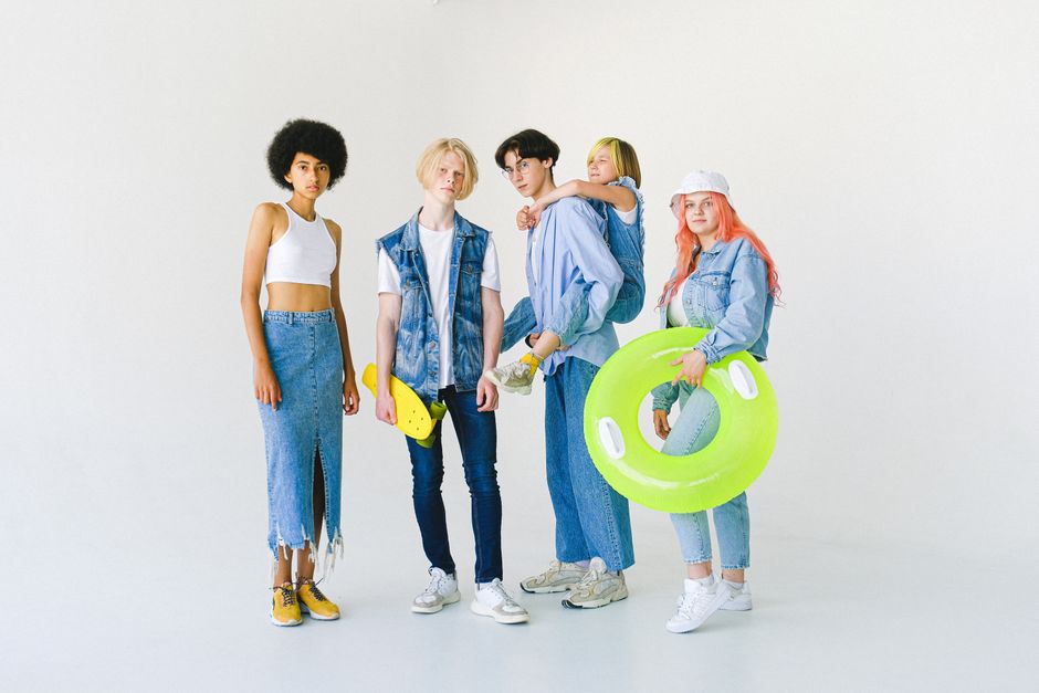 A stylish group of creators in streetwear posing against an urban neon backdrop