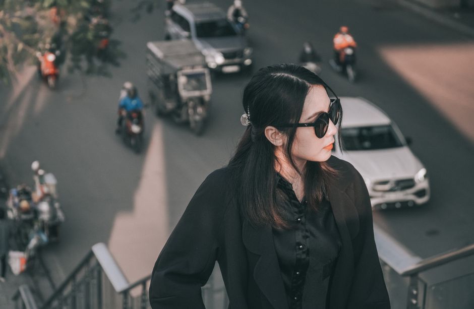 A stylish woman wearing sunglasses and a leather jacket, representing the cool and edgy aesthetic of modern nicknames