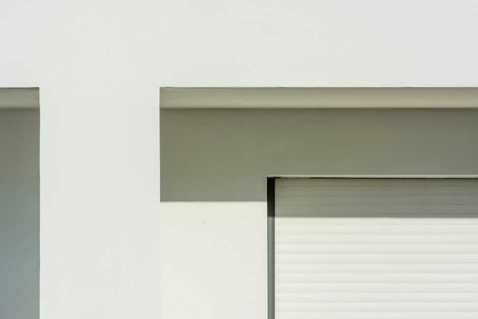A sunlit modern beach house with influencers filming lifestyle content on the balcony