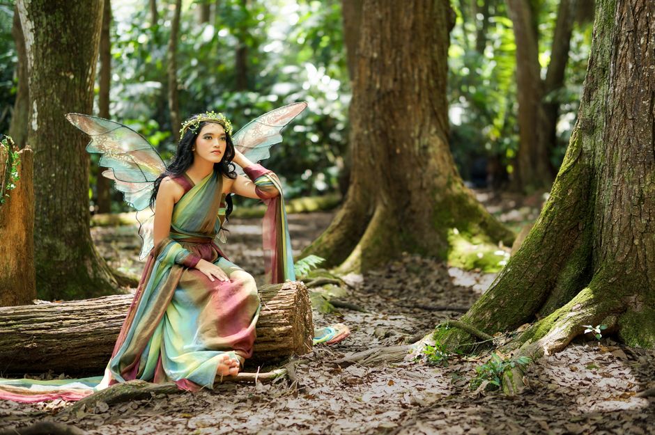 A whimsical enchanted woodland setting with bioluminescent mushrooms and mossy trees representing fairycore aesthetics