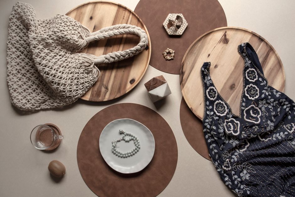 Aesthetic flat-lay view of two coffee cups, a film camera, and a notebook on a rustic table