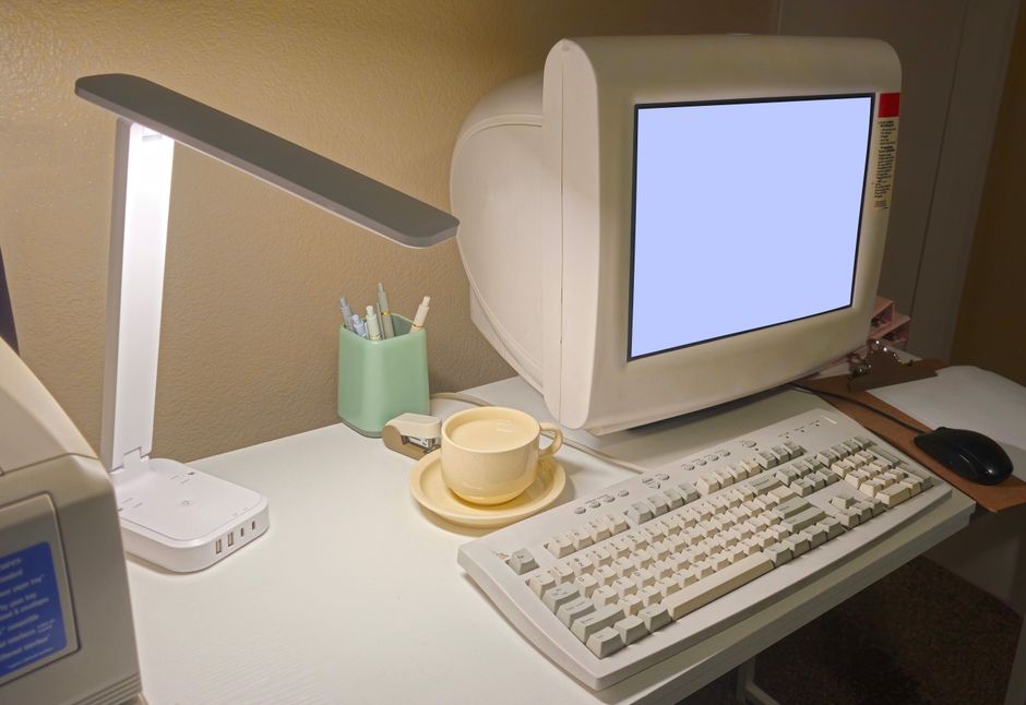Aesthetic study desk with open vintage books, fountain pen, and a tablet displaying BookTok video feed