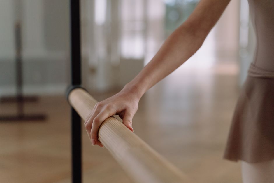 Close-up of ballet shoes and dynamic dance studio movement with ambient lighting