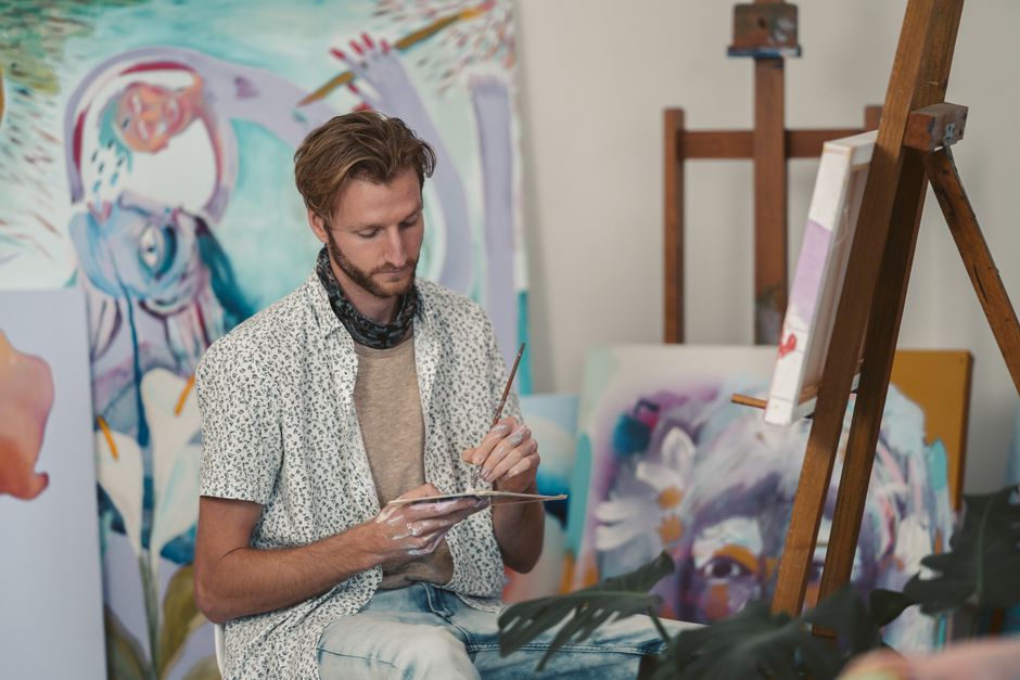 Creative creator working on a laptop while setting up a social media profile branding kit