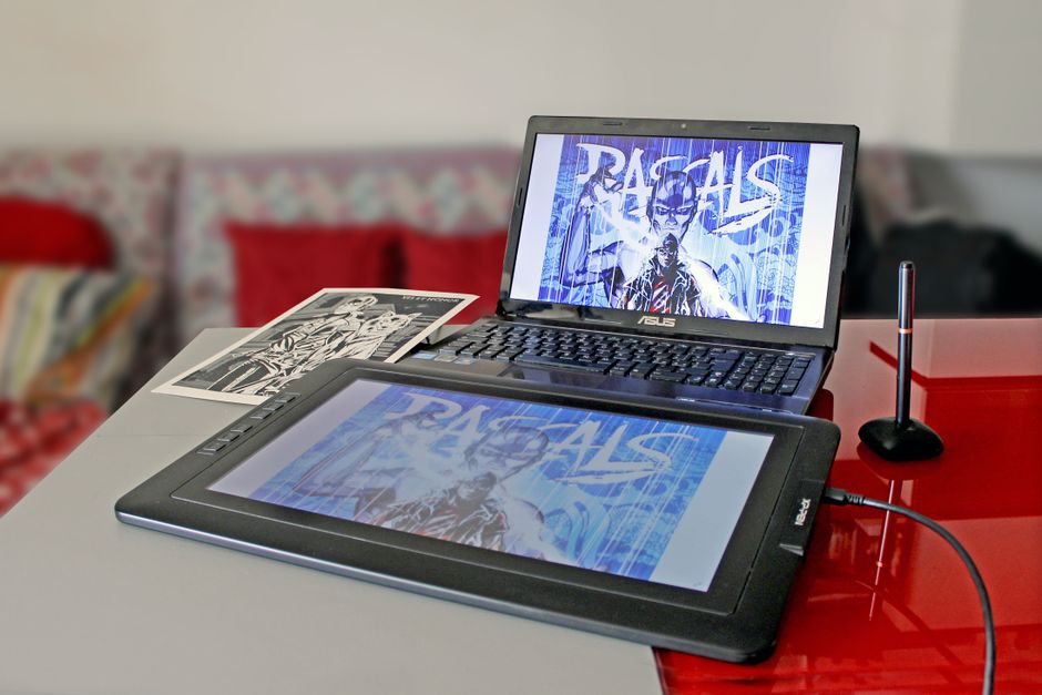 Creative workstation with a keyboard, notebook, sketchbook, and visual branding color swatches