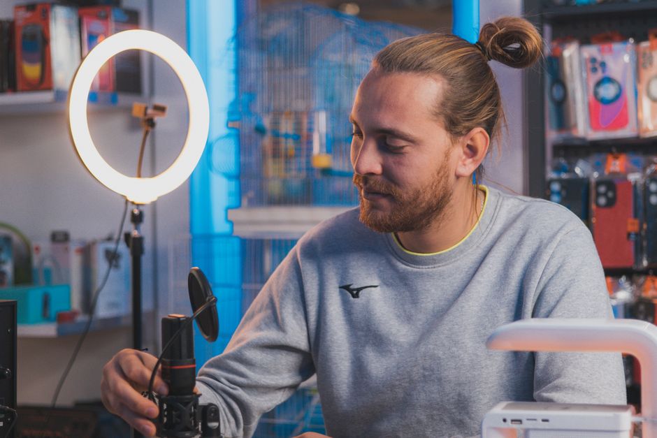 Creator recording a whimsical culinary video on TikTok using natural window lighting