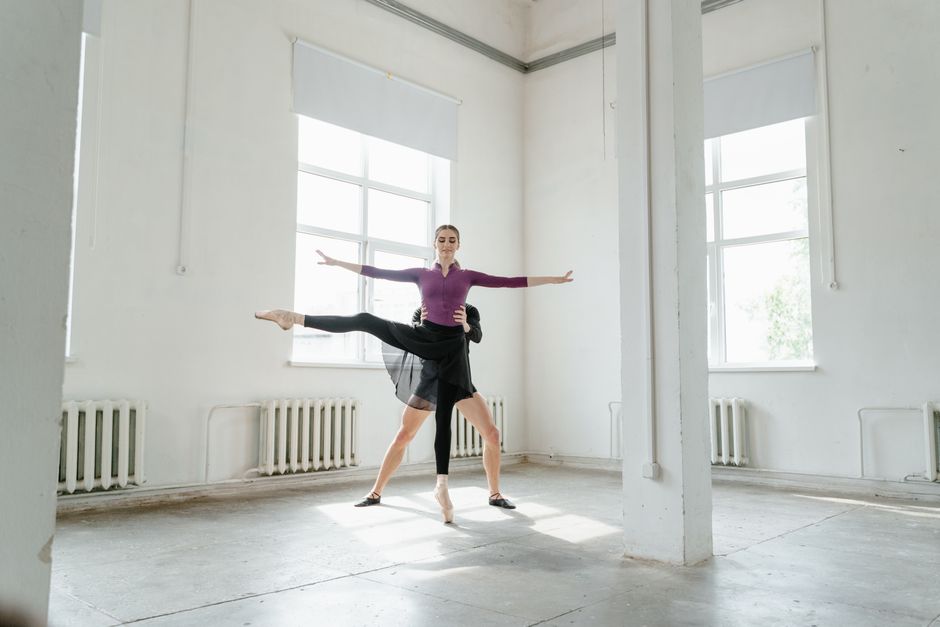Dancer practicing intricate K-pop choreography in front of a dance studio mirror