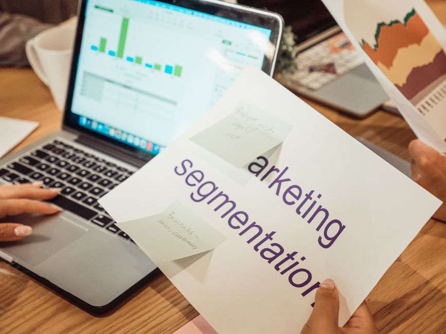 Digital marketing team analyzing creator performance metrics and estimated campaign costs on a modern analytics dashboard