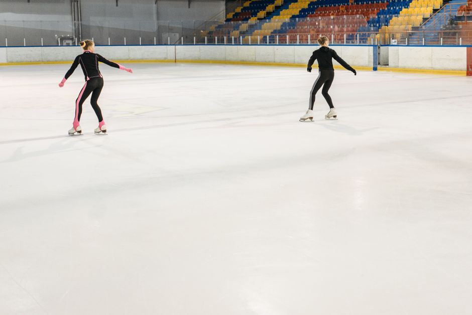 Figure skaters backstage capturing dynamic social media content on their smartphones