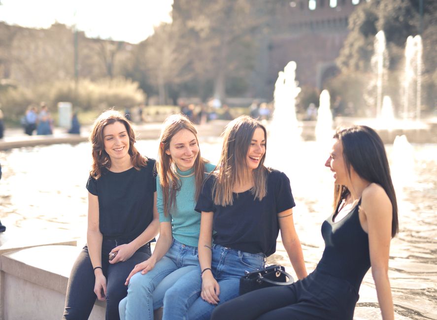 Friends laughing together while filming a funny viral trend on a phone