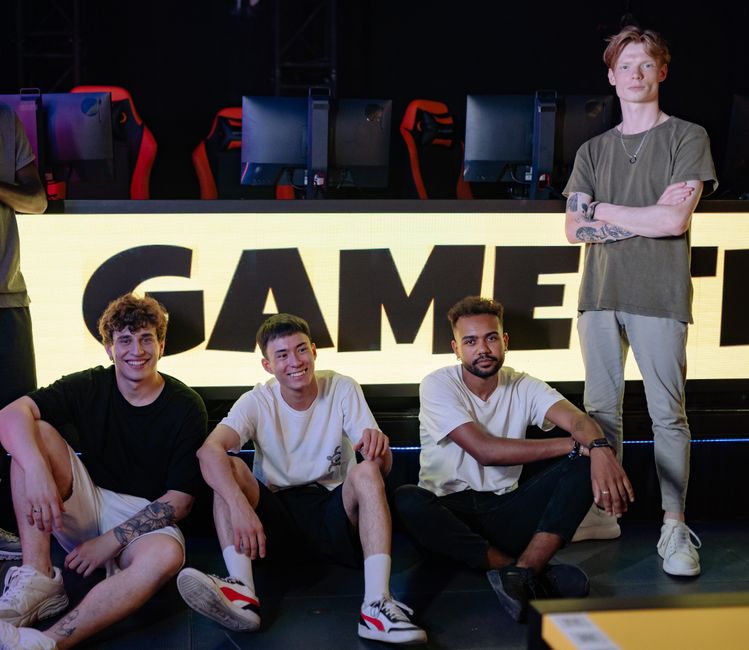 Gamers and content creators brainstorming unique TikTok nicknames on a neon-lit streaming desk setup