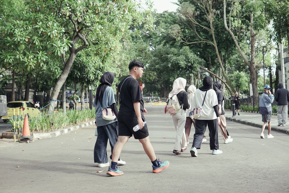 Group of street dancers in urban streetwear performing synchronized hip-hop choreography