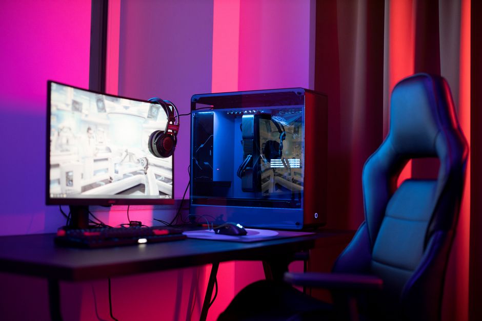High-tech gaming setup with glowing RGB keyboards and neon streaming overlays displaying creator handles