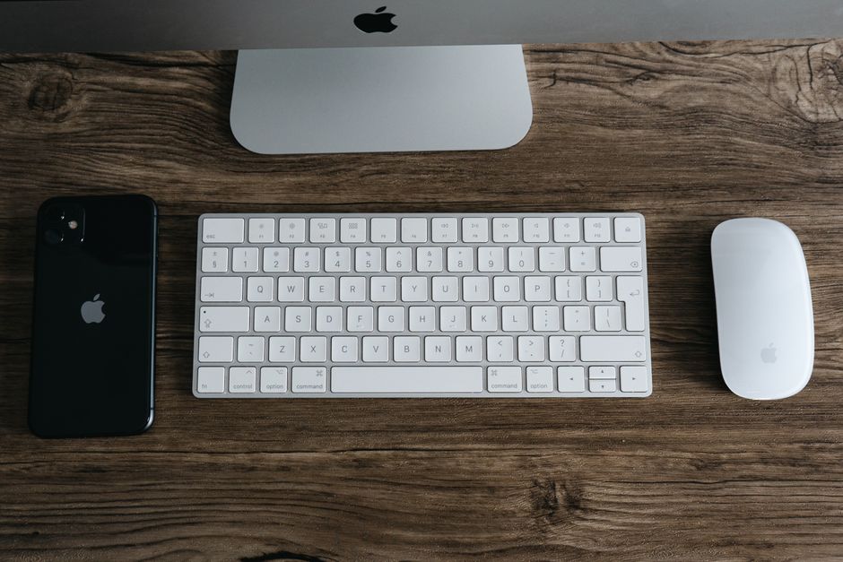 Minimalist desktop workspace with a smartphone displaying clean, short social media typography
