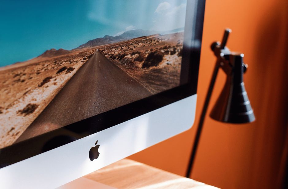 Minimalist workspace setup featuring content creation tools and a tablet displaying synchronized social media channels
