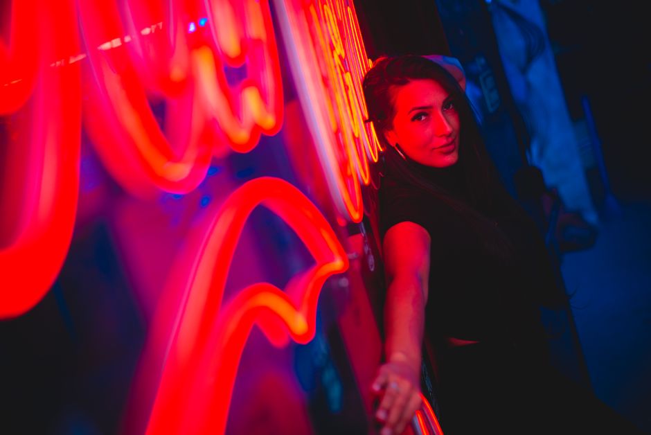 Moody neon lighting with a smartphone screen showing stylish dark-mode profile names