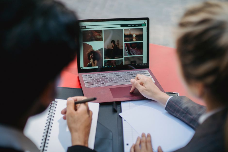Professional content creator filming vertical video with studio lighting, camera equipment, and a laptop displaying analytics