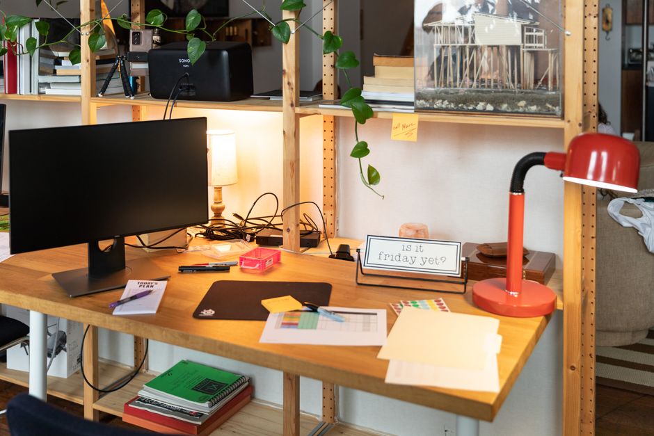 Relatable funny workspace desk with sticky notes and an ironic ceramic coffee mug