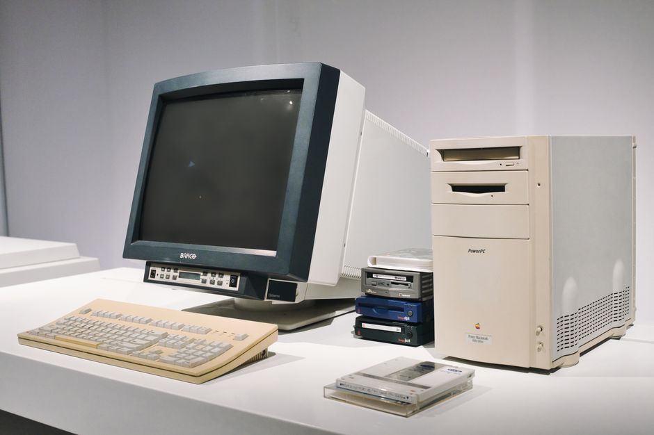 Retro desktop computer monitor displaying an old operating system with pixelated popups and neon cyber graphics