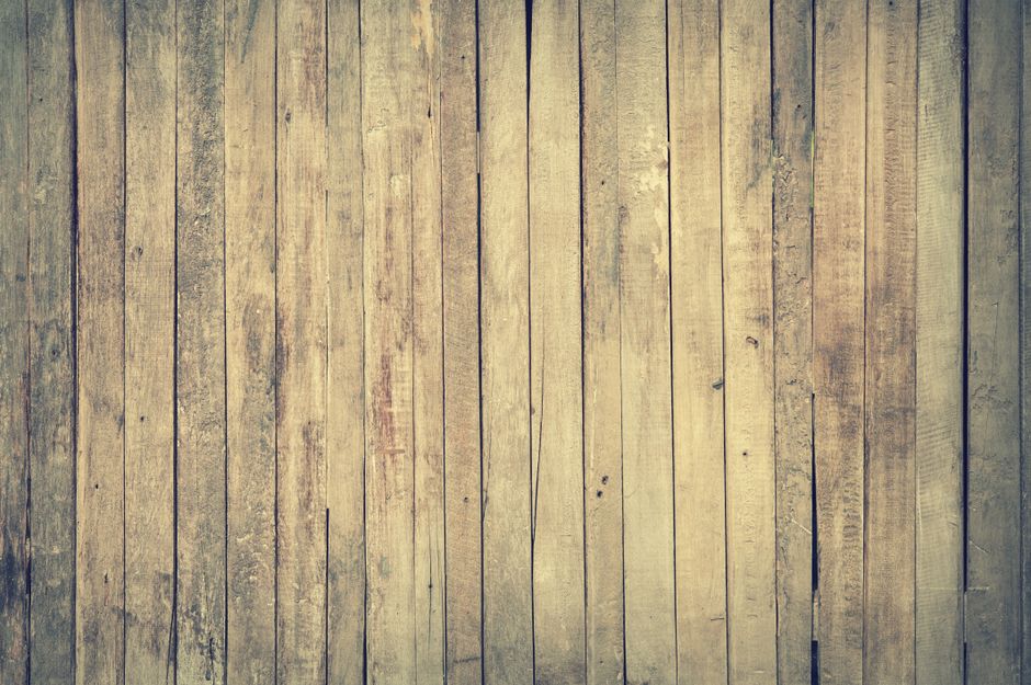 Rustic wooden fence and open pasture under a wide sky representing the country aesthetic