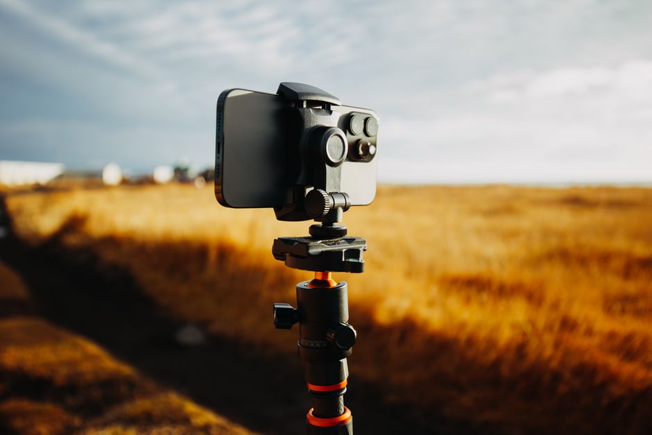 Smartphone mounted on a ring light recording a dance creator in a neon studio