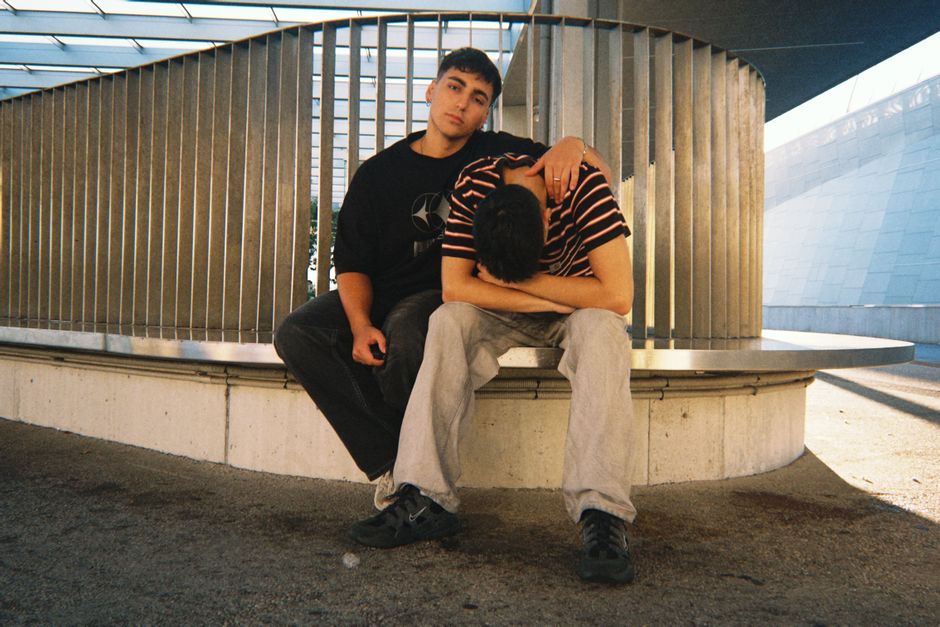 Two friends sharing a warm hug, highlighting a sweet height difference with bright, natural lighting