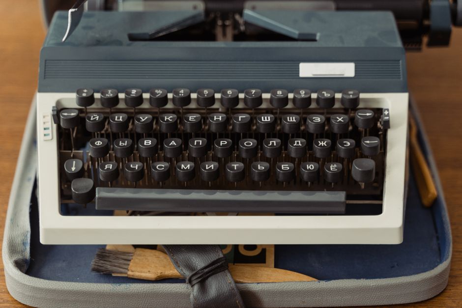 Vintage typewriter with a handwritten note in dark moody lighting